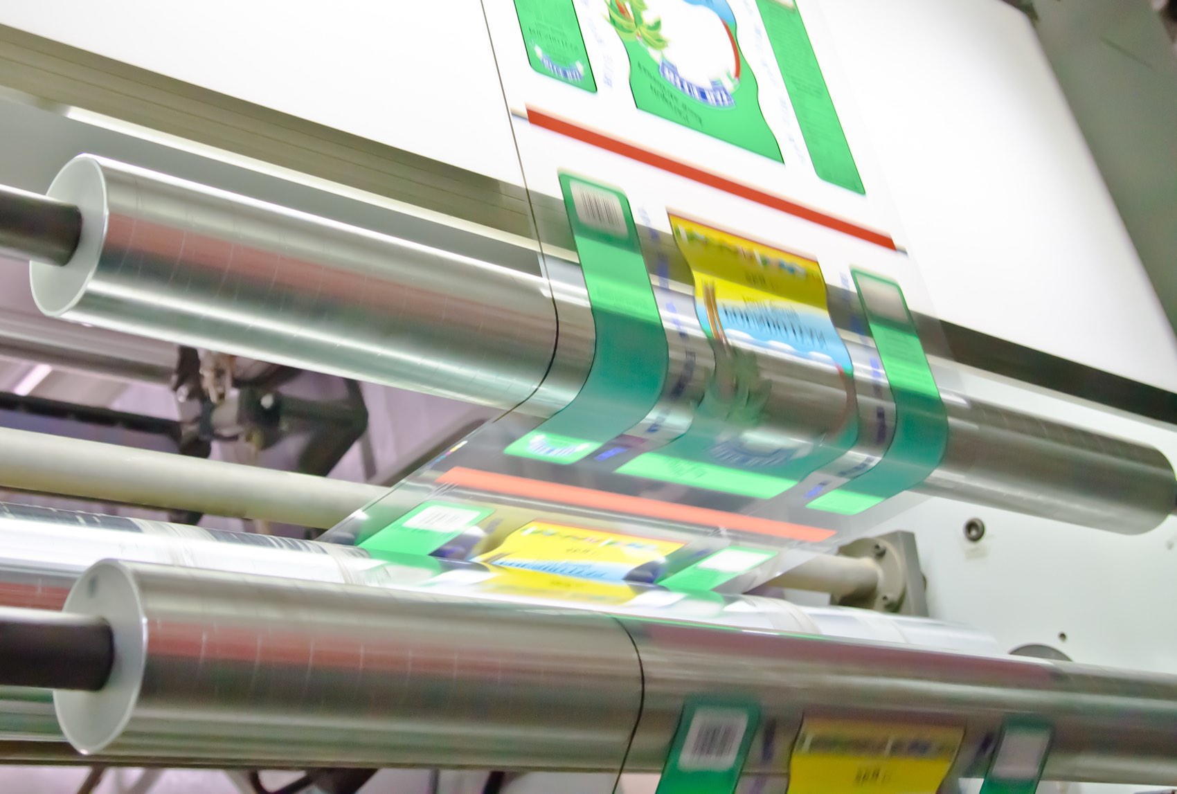 Printed packaging film running through a pouch-making line