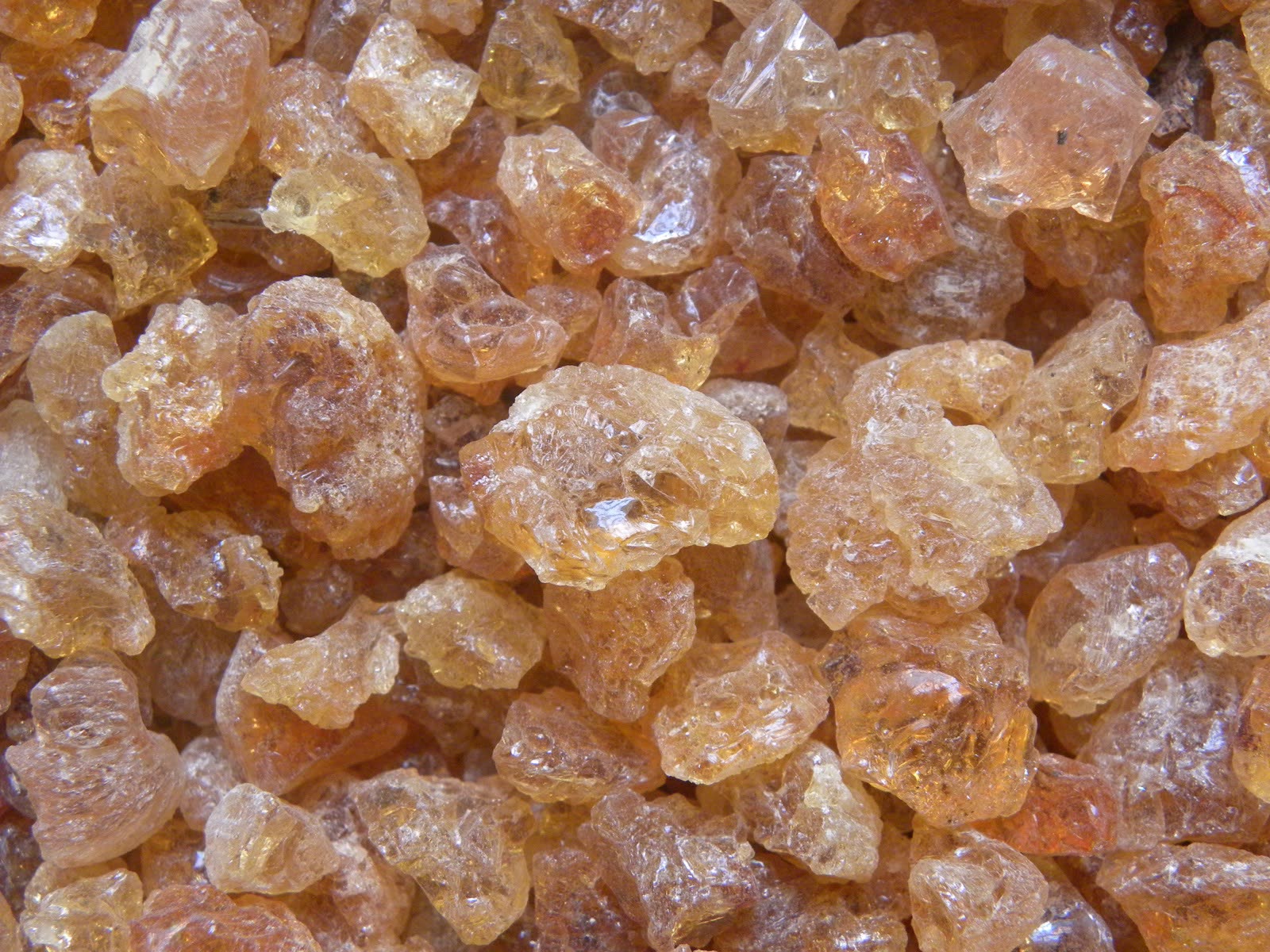 Amber kibbled gum arabic lumps filling the frame